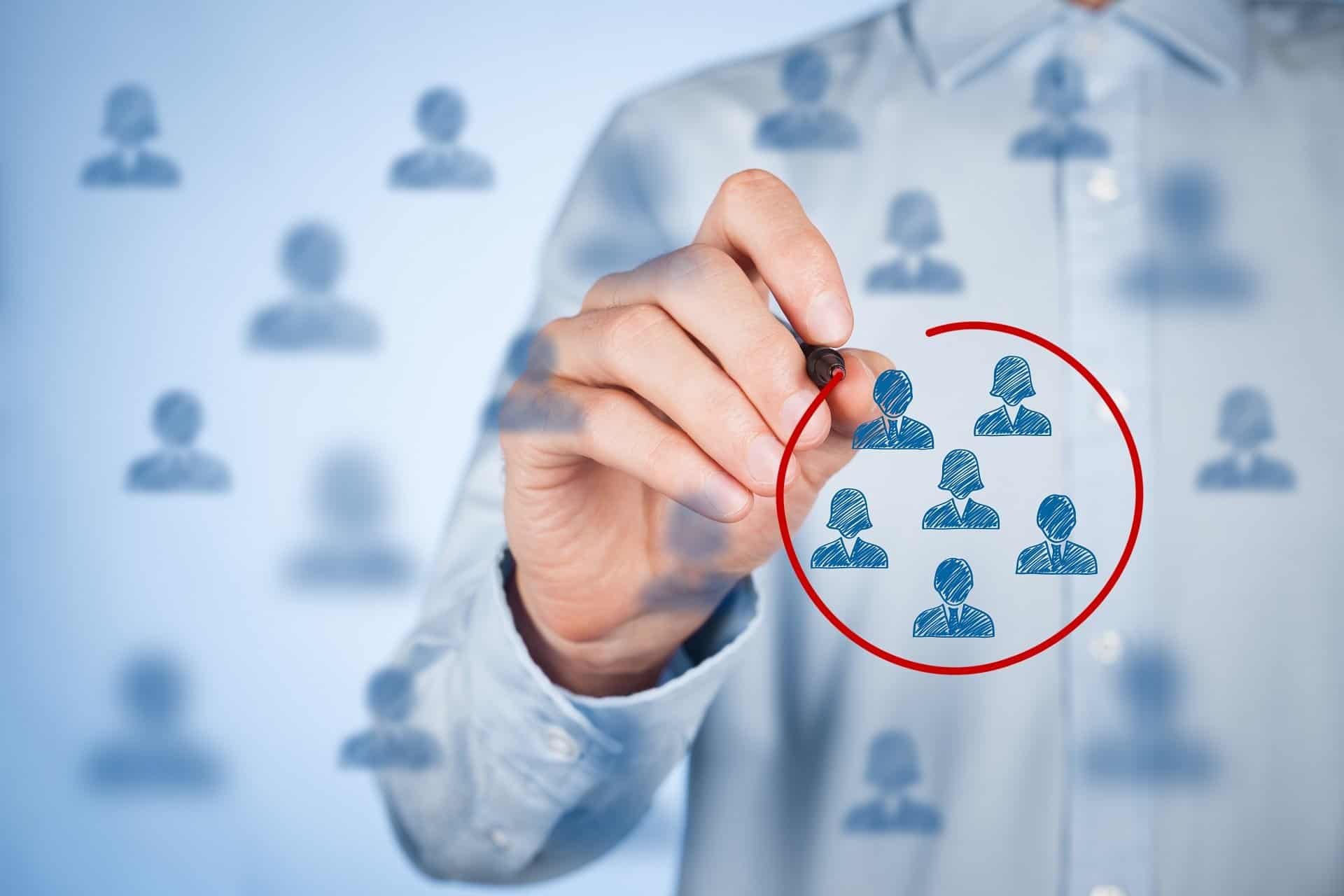 Finding your target audience; man circling a group of icons depicting a target audience.