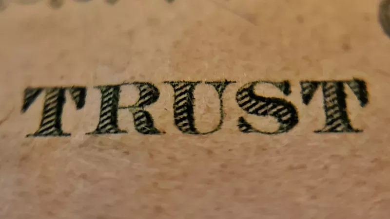The word trust printed on a yellowed certificate.