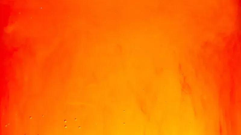 A closeup of orange soda in a glass.
