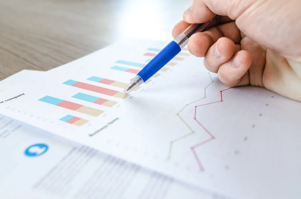 SEO analysis for website printed report. Man reviewing the report with a blue pen.
