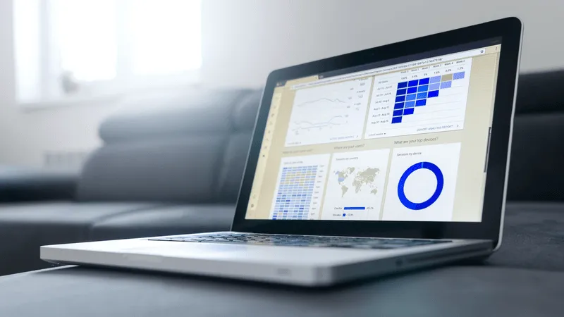 Notebook work with statistics on sofa business