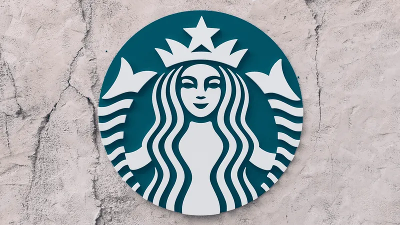 Photograph of the Starbucks logo on a stucco wall.
